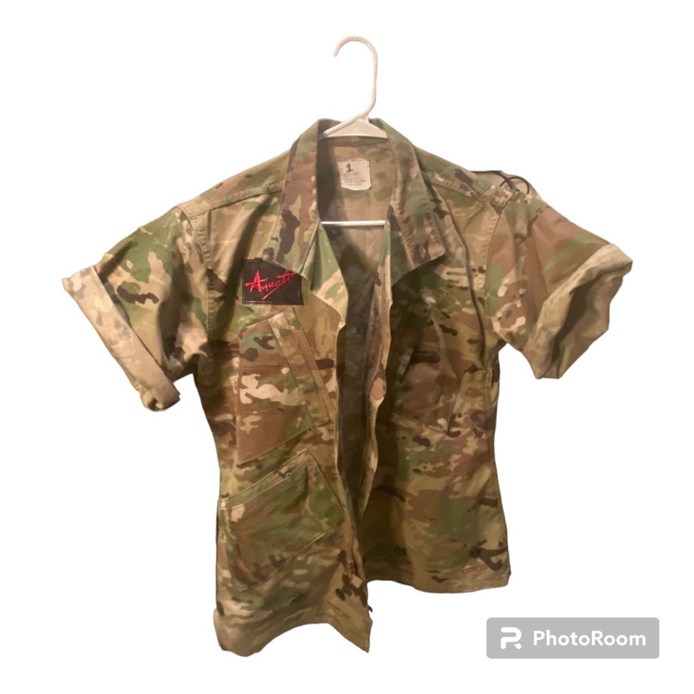 Upcycled short sleeve army fatigue jacket with patch for added detail.